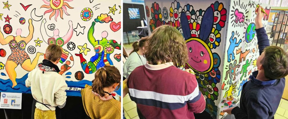 Group of people painting a large, colorful mural with joyful figures, sun and stars on a wall in an art workshop.